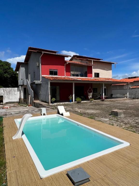 a swimming pool in front of a house at Espaço Familiar com Piscina in São Luís