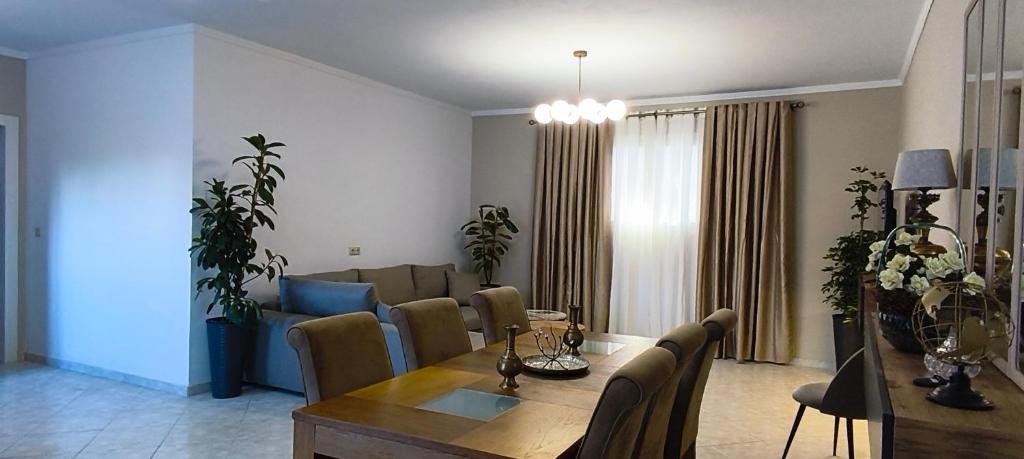 a living room with a dining table and a couch at Golden rose in Corfu