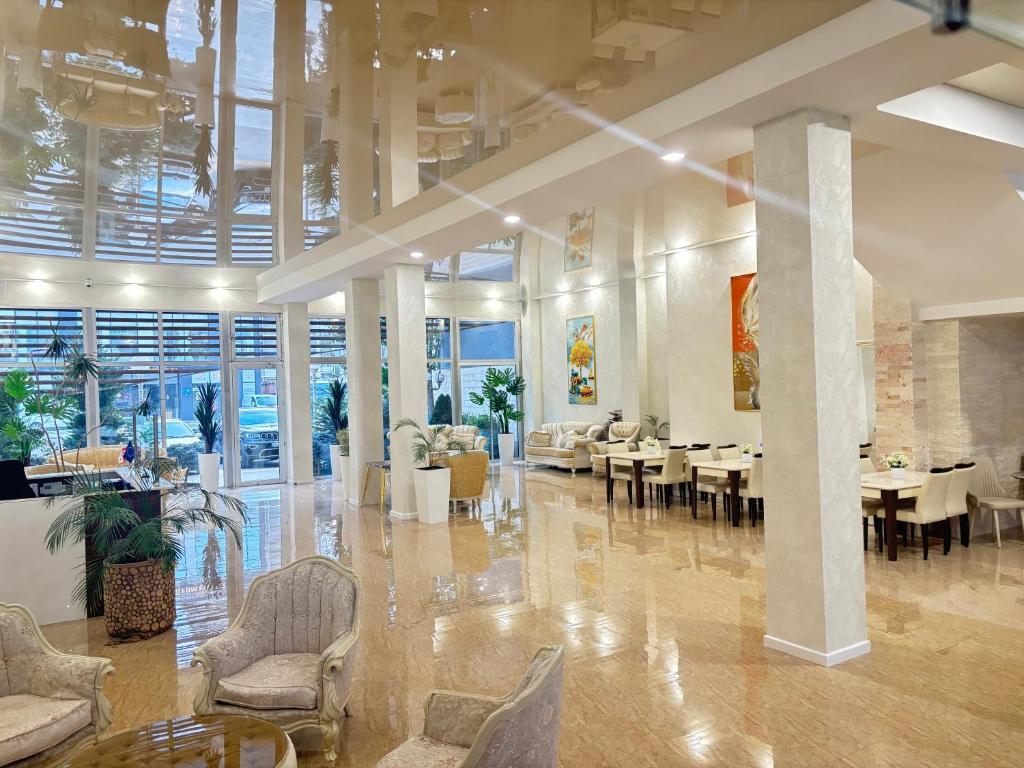 a dining room with tables and chairs in a building at Agava Tbilisi in Tbilisi City