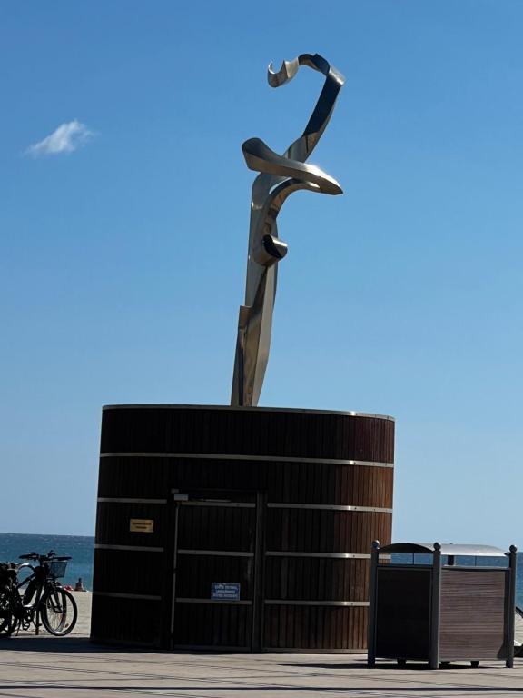 a statue of a person on a skateboard in front of a building at Escale Sud in Canet-en-Roussillon