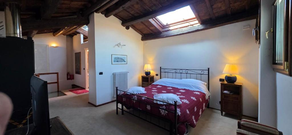 a bedroom with a bed and a tv in a room at Skyline Virgilio SUITE sottotetto vista MARE parking in San Marino