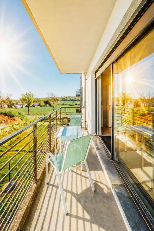 a balcony with a glass table and a view at Stunning 2 bed Mamer free parking in Mamer