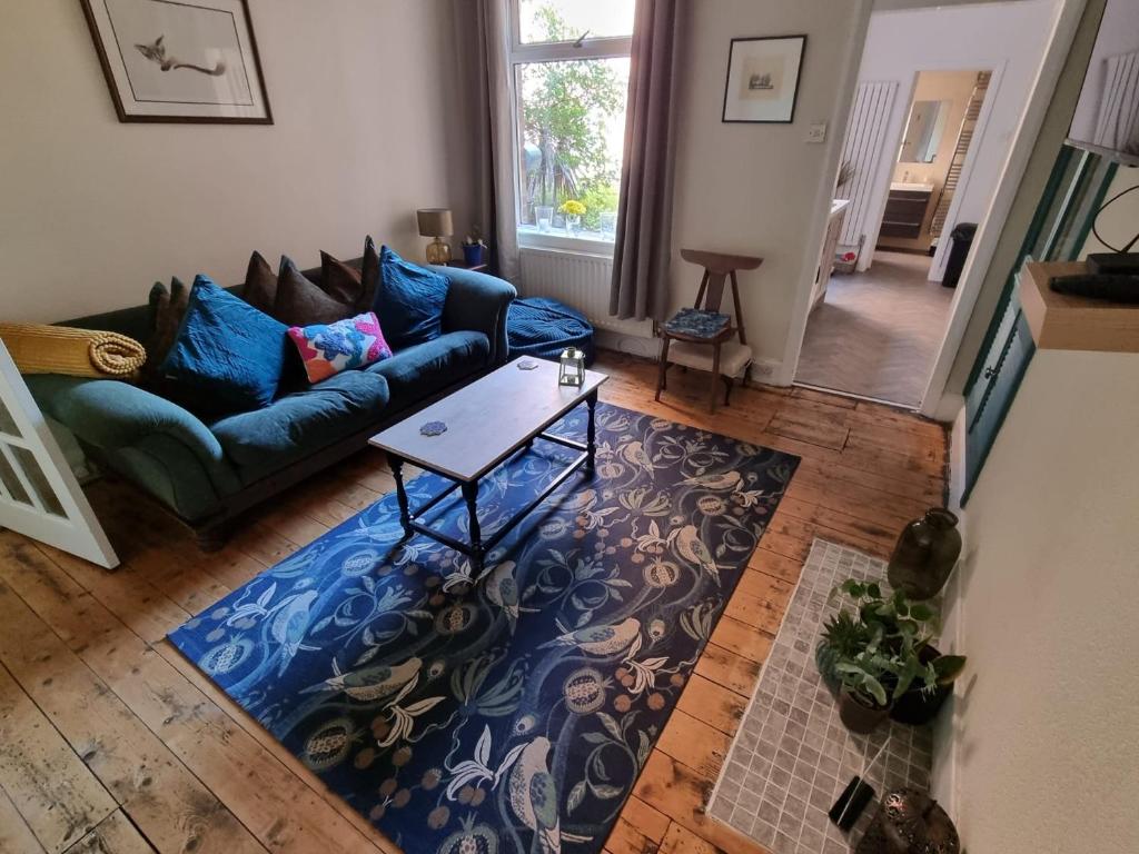 a living room with a couch and a table at Stay at 128 in Walker Gate