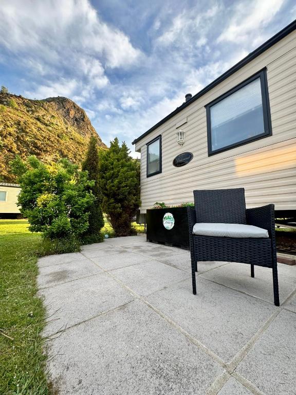 a black and white chair sitting in front of a trailer at The Conwy Escape in Conwy