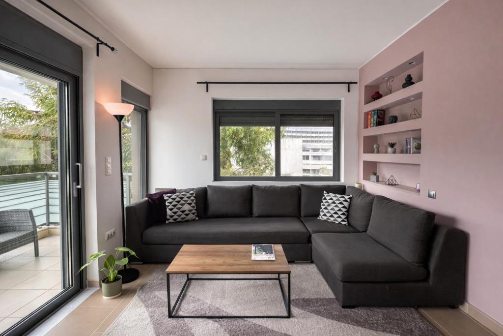 a living room with a couch and a table at Fos Opus - Seaside Residence Rhodes in Ixia