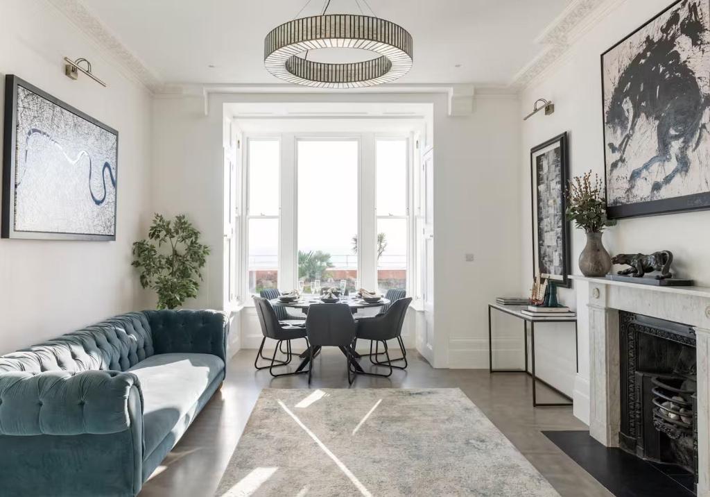 a living room with a couch and a table at 3 Bedroom, 3 bathroom large flat with sea views! in Hastings