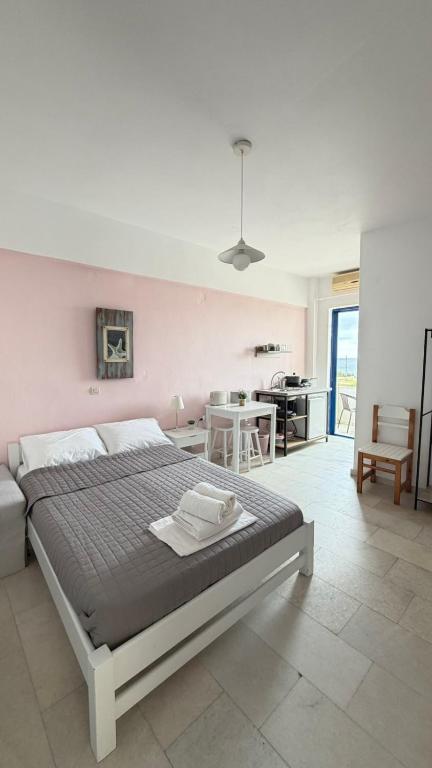 a bedroom with a large bed and a living room at Ippokampos in Moutsoúna