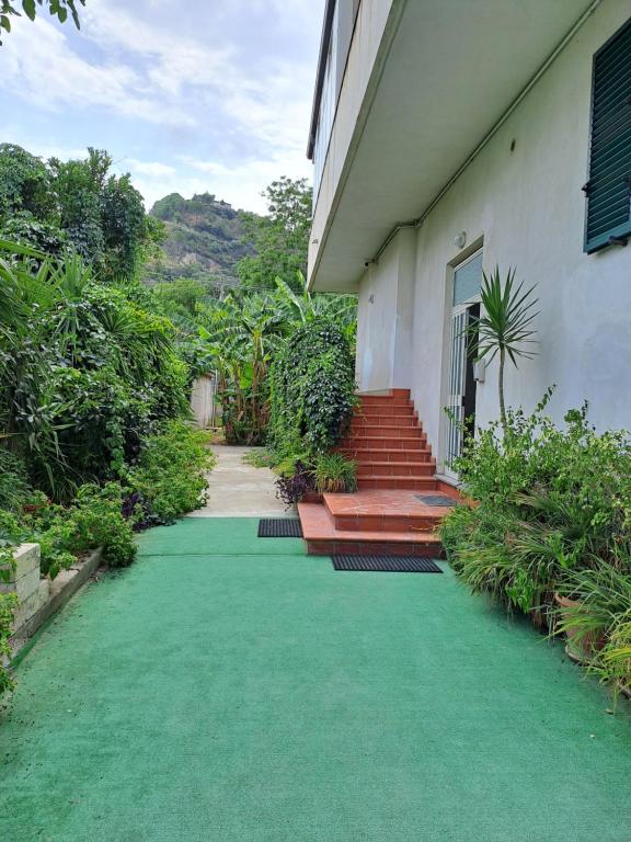a house with a green lawn in front of it at Villa Anna Tropea in Tropea
