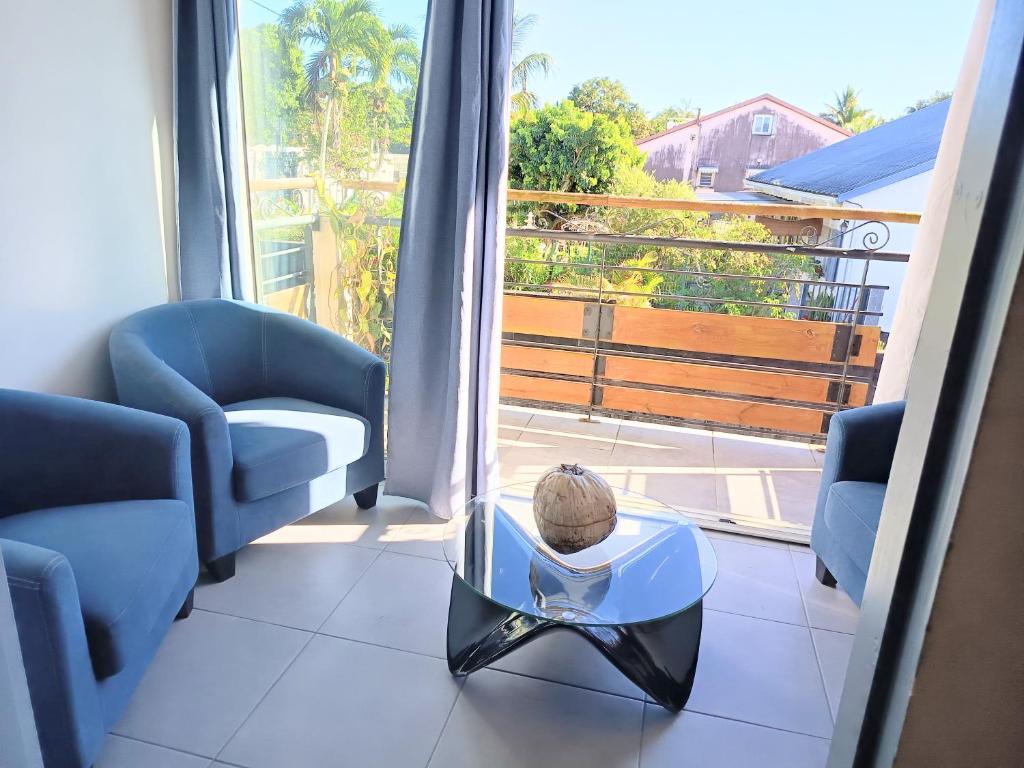 a room with two chairs and a table and a window at Gîte Holidays mon repos in Saint-André