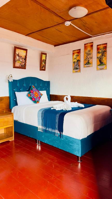 two beds in a room with blue and white at Hostal sambleño cusco Piero suite in Cusco