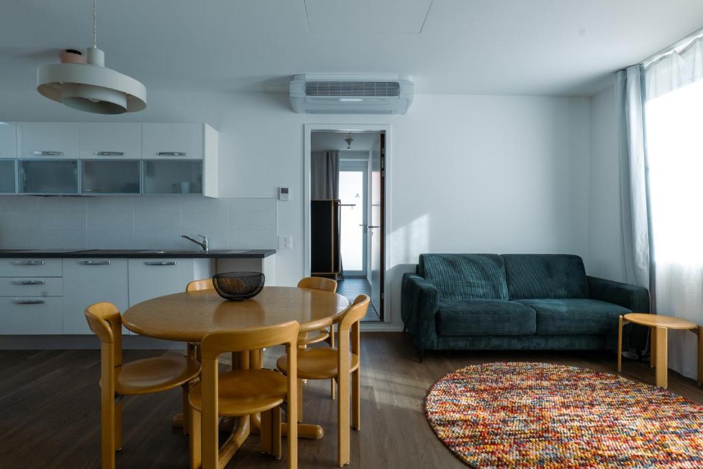 a living room with a table and chairs and a couch at Il Platano Guest House in Quartino