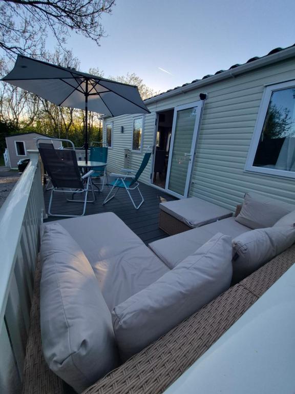 a large couch sitting on the deck of a house at 22 Washbrook Way in Ashbourne