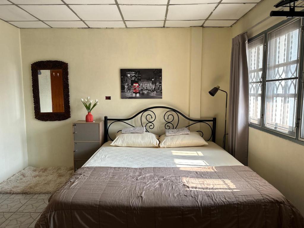 a bedroom with a large bed with two pillows at The Station Hostel in Sathani Ayutthaya