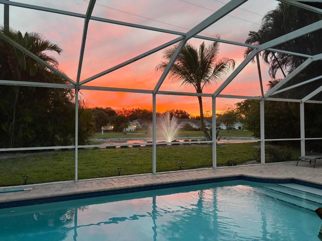 a swimming pool with a sunset in the background at Villa Vera with Lake view in Naples