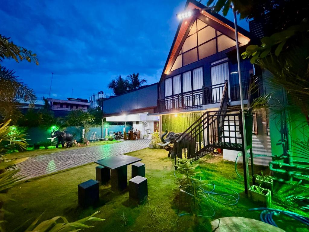 a building with a bench in front of it at night at Batti Lagoon Hotel in Batticaloa