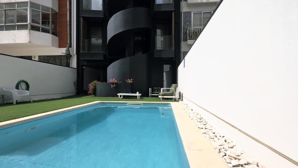 a swimming pool on the side of a building at A Proa do Moliceiro - iConik Design Apartments in Aveiro