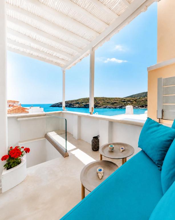 a view of the ocean from the balcony of a house at Lasia Boutique Apartment in Andros