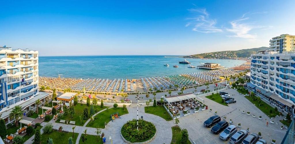 a beach with a crowd of people and the ocean at Nada SeaView Apartment in Shëngjin