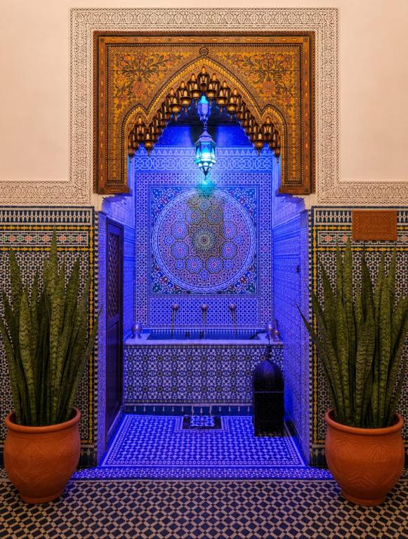 a blue room with two potted plants in front of it at RIAD YOUSSEF in Fez