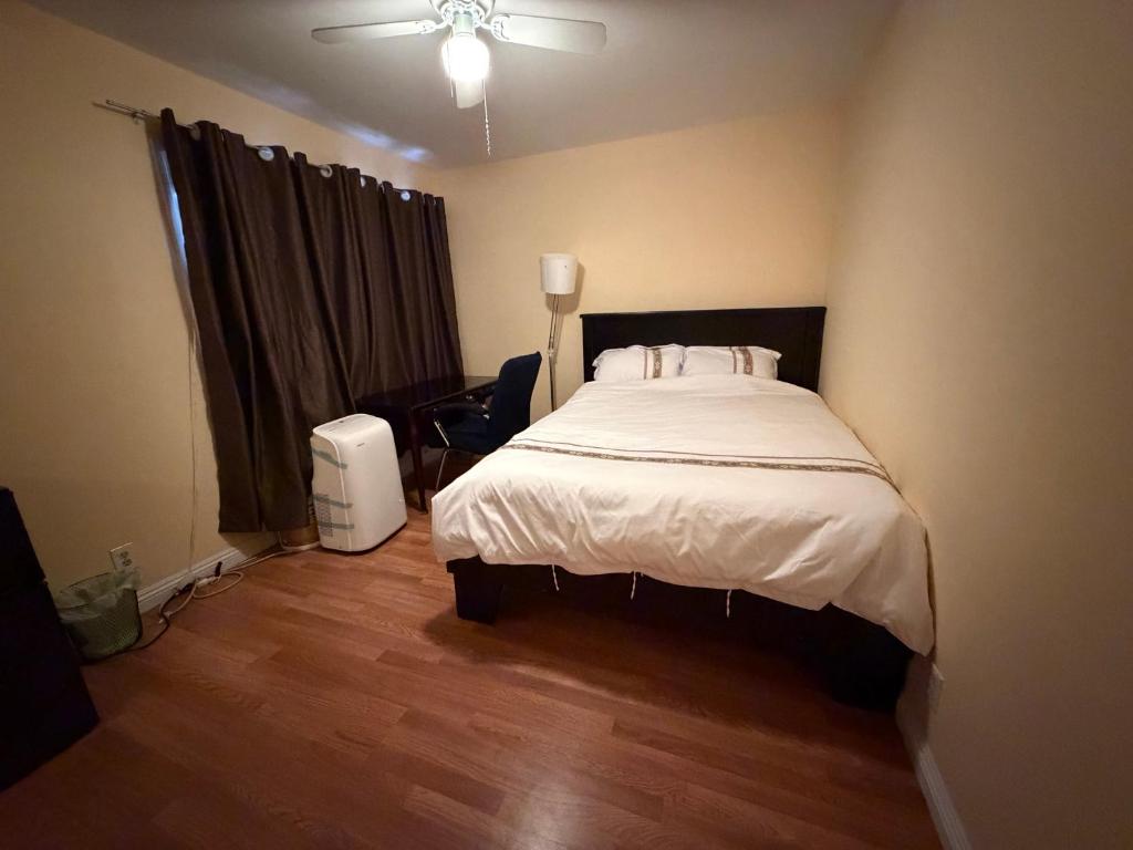 a bedroom with a bed and a ceiling fan at Citrus Loft - Quiet and convenient female only in Covina