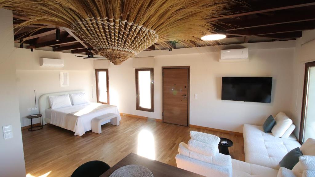 a living room with a bed and a couch at Ianos Living Spaces - 03 in Korinthos