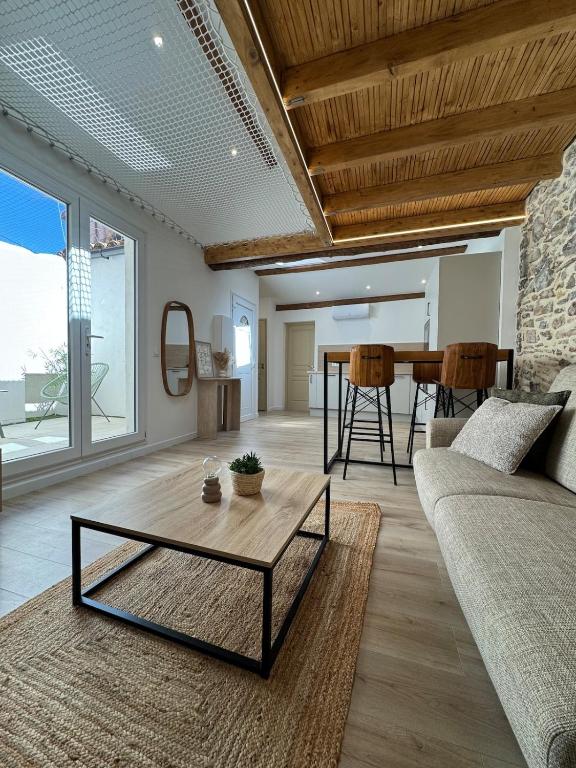 a living room with a couch and a table at T3climatisé Hyper centre 2 Chambres Terrasse in Sète