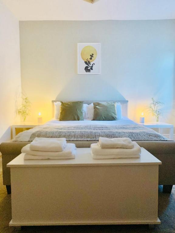 a bedroom with a bed with towels on a table at Escape to Lytham St. Annes in Lytham St Annes
