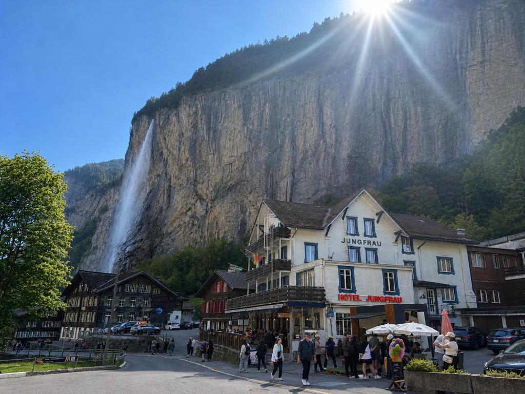 a group of people standing in front of a mountain at Hotel Restaurant Jungfrau in Lauterbrunnen