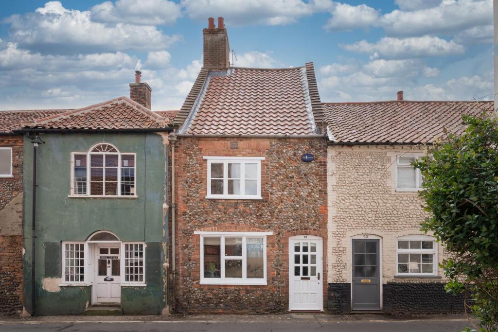 an old brick house with white windows and green paint at Lion Cottage - Dog-Friendly 3-Bed in Heart of Holt in Holt