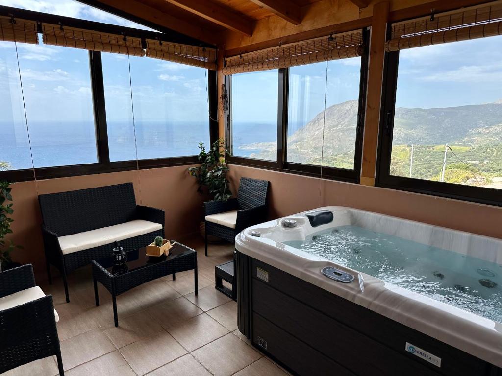 a large bath tub in a room with windows at Seaview Villa Liandroy in Sellía