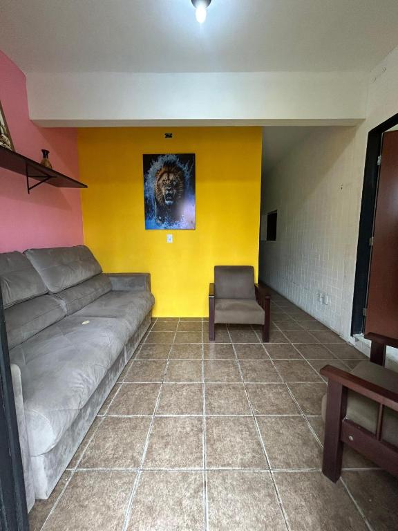a living room with a couch and a chair at Jampa Pousada Sb in João Pessoa