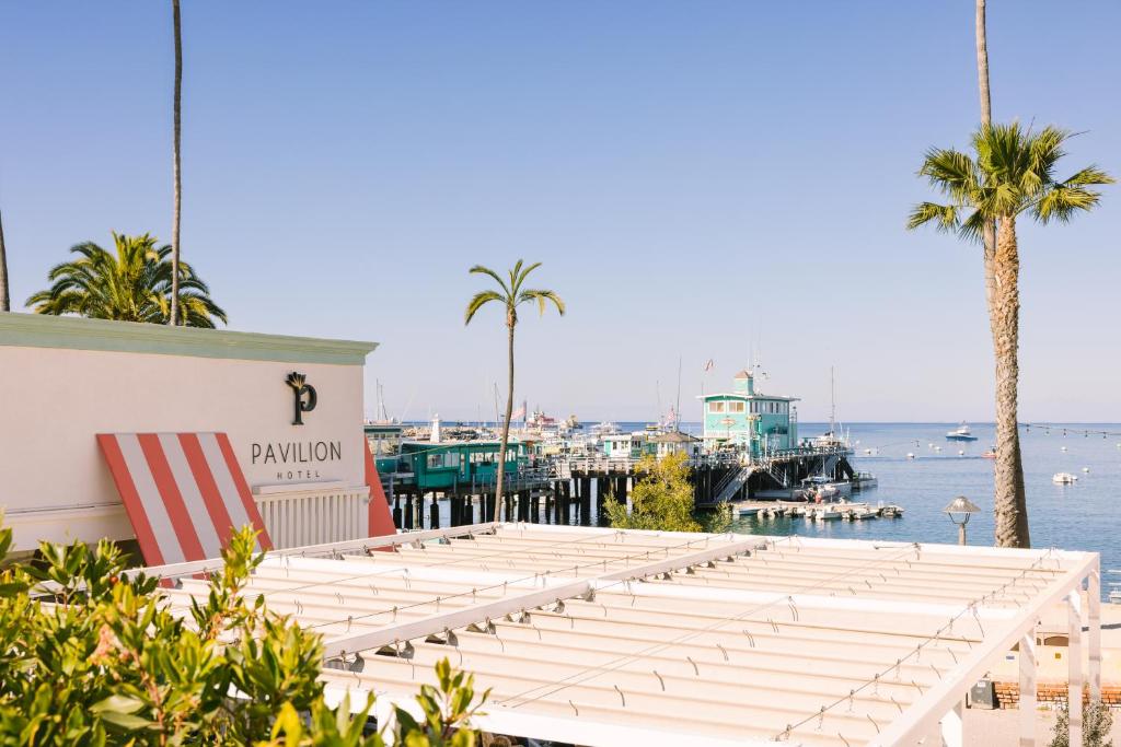 a row of benches in front of a marina at Pavilion Hotel in Avalon