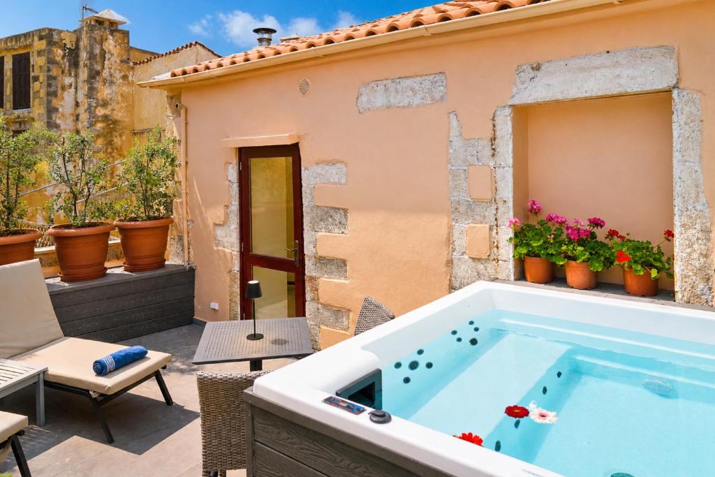 a hot tub on the patio of a house at Venetian Palace Chania - Adults Only in Chania