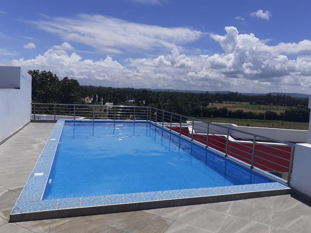 a large swimming pool on the roof of a house at Asante Studio in Mtwapa
