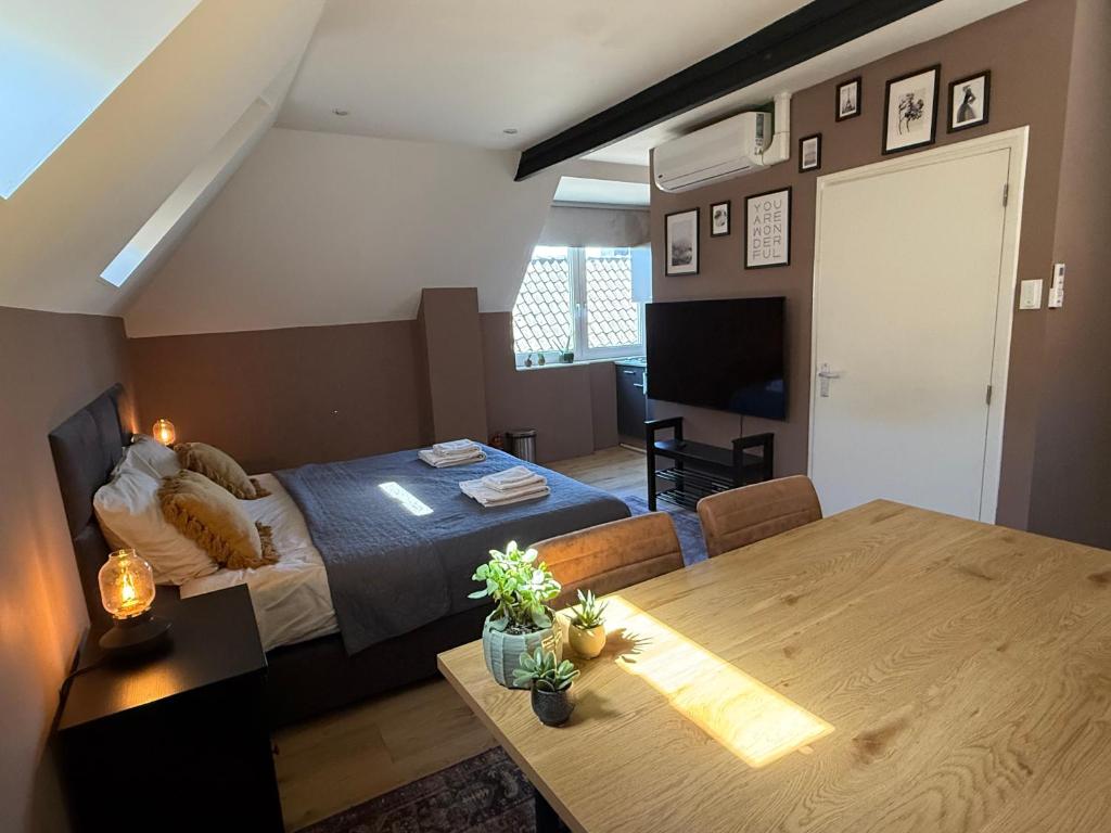 a bedroom with a bed and a dining room table at D10 Apartments in Breda