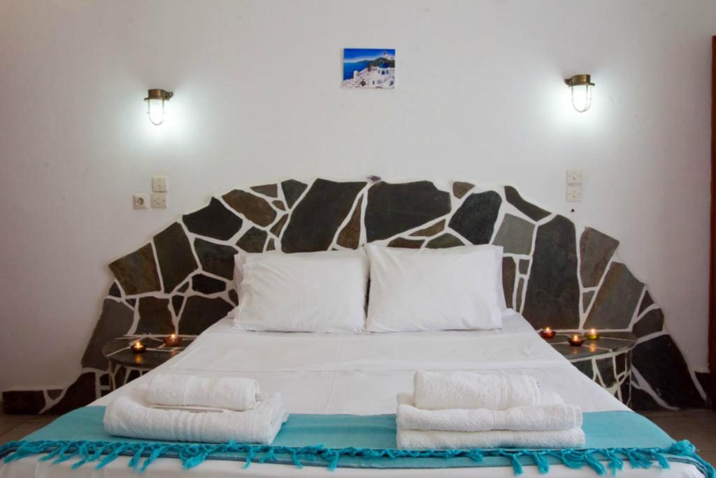 מיטה או מיטות בחדר ב-Hotel Faros
