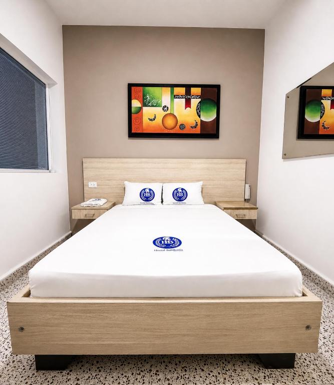 a bedroom with a large bed in a room at Hotel Babilonia Boutique in Cúcuta