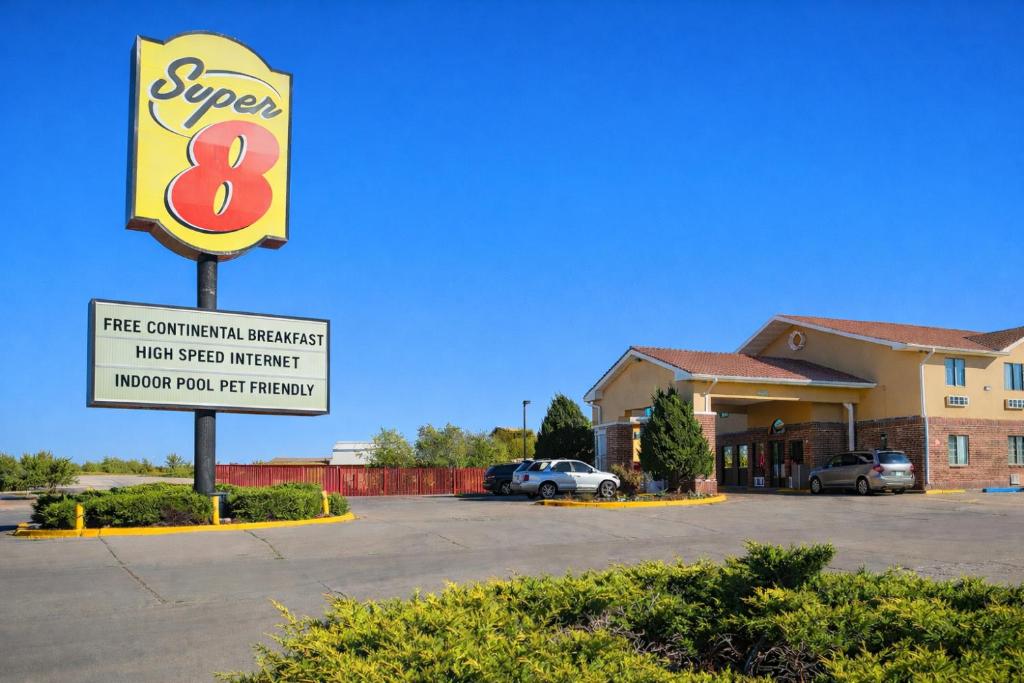 a sign in a parking lot in front of a hotel at Super 8 by Wyndham Gallup in Gallup