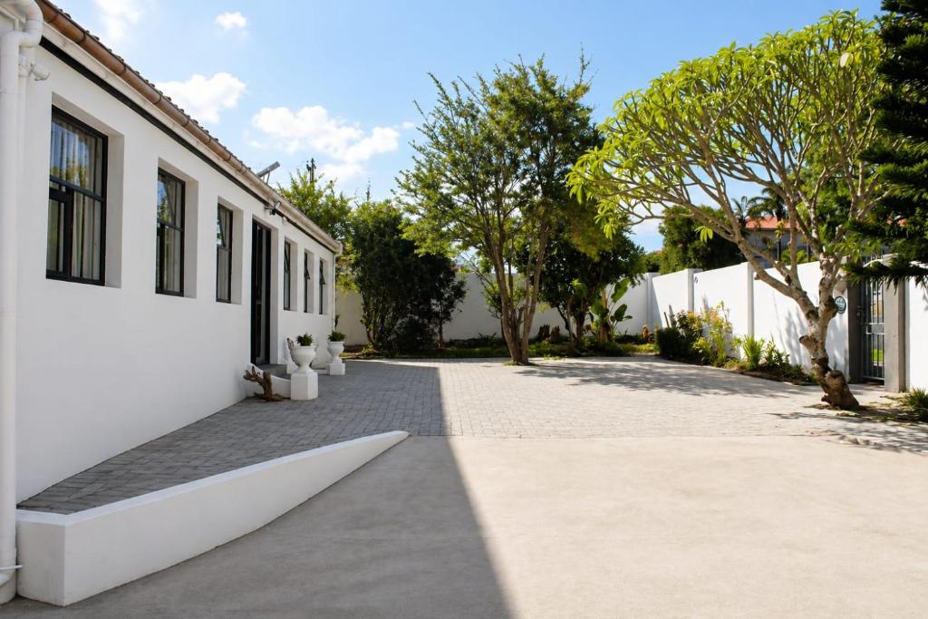 a courtyard of a white building with trees at The Grace and Hope House in Bunkers Hill