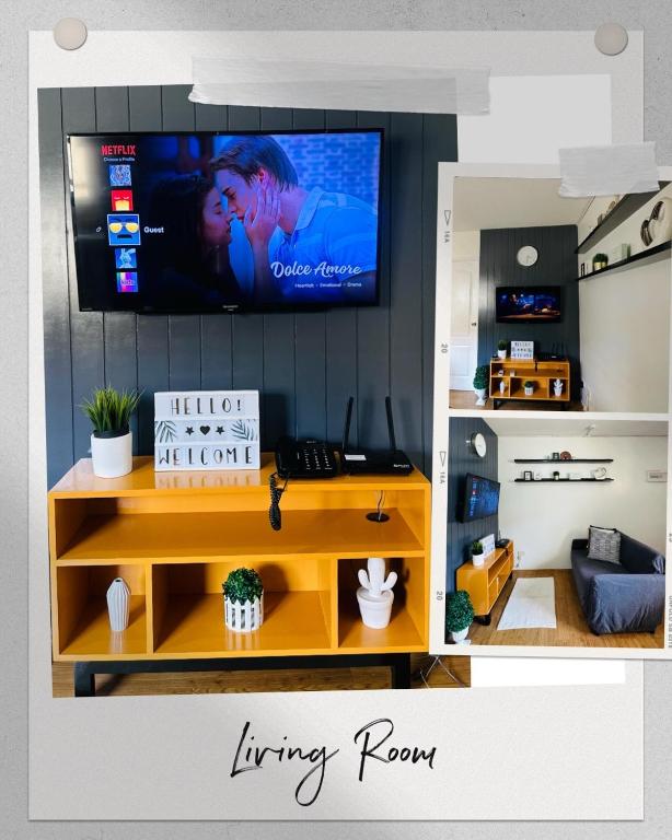 a living room with a tv on a wall at A cozy modern design Unit 6425 in Cebu City