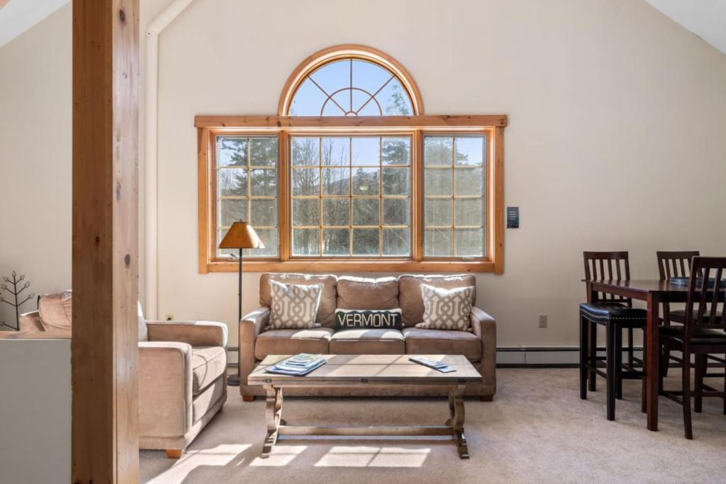 a living room with a couch and a table at Sugarbush Seclusion in Vermont in Waitsfield