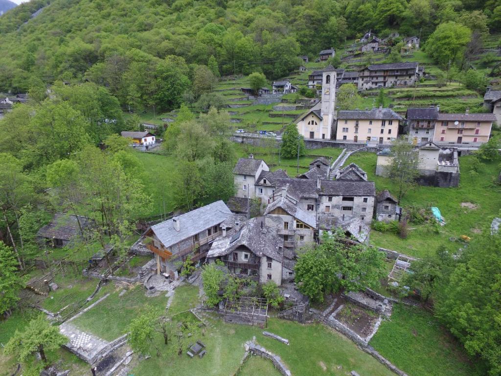 an aerial view of a village on a hill at Hostelleria in Linescio