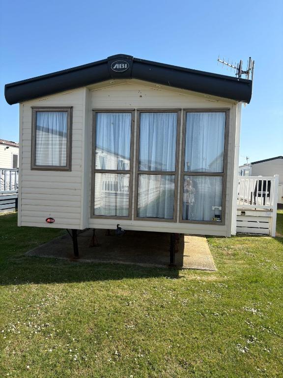 a tiny house on a stand in a yard at Sunrise in Selsey