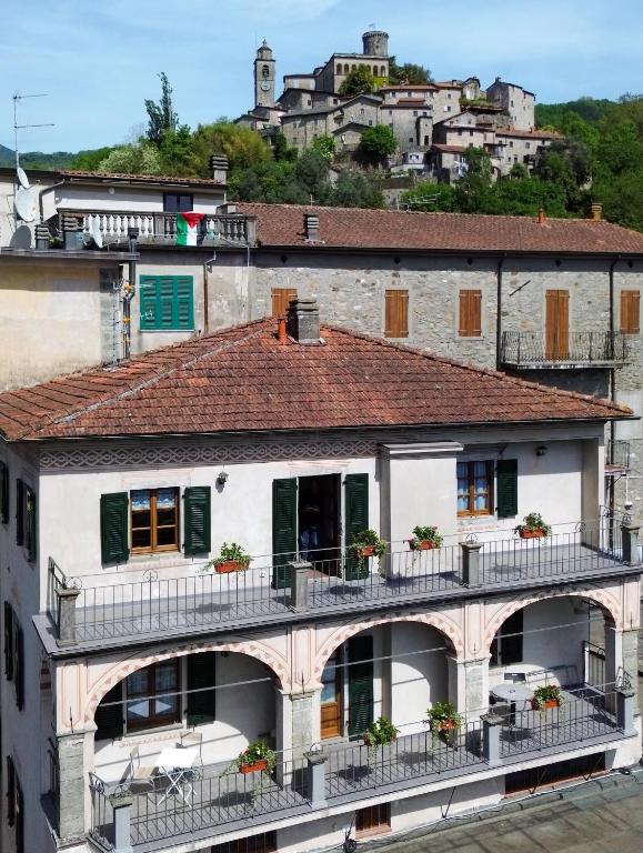 a group of buildings with balconies and a mountain at The River House in Bagnone