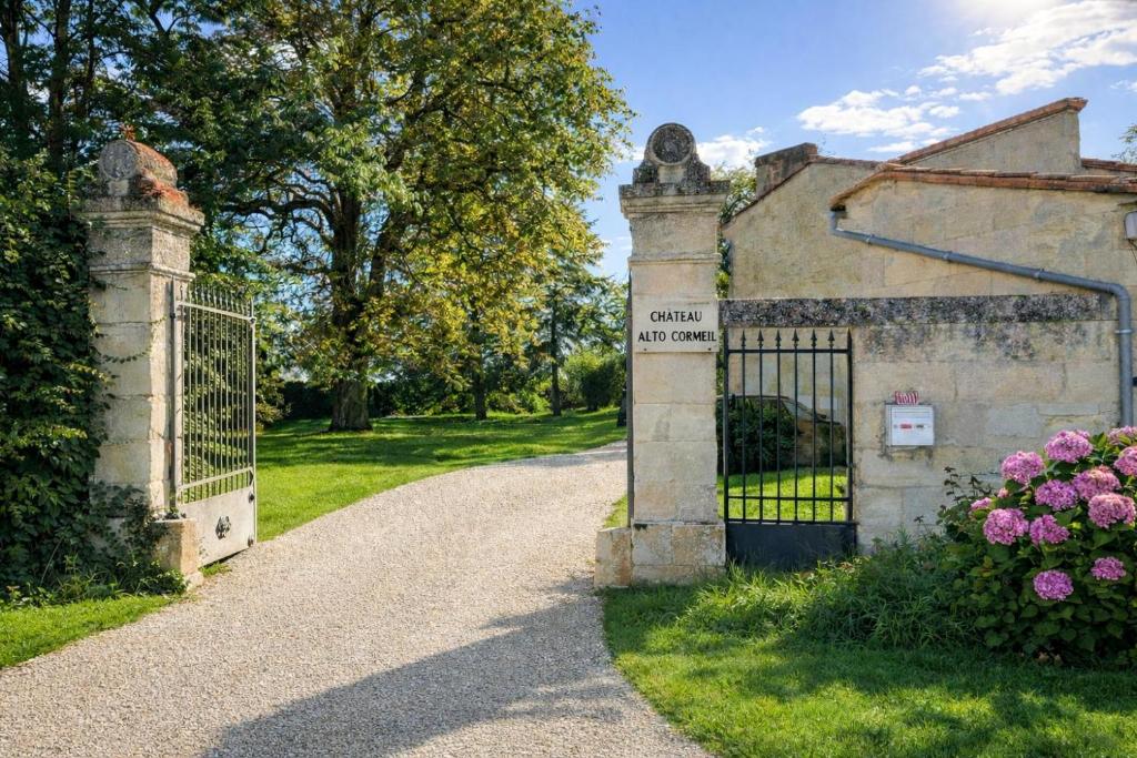 an entrance to an old stone building with a gate at Château Alto Cormeil in Saint-Émilion