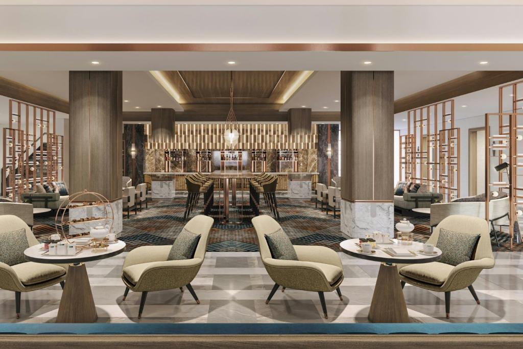 a lobby with tables and chairs and a bar at Hamamatsu Marriott Hotel in Hamamatsu