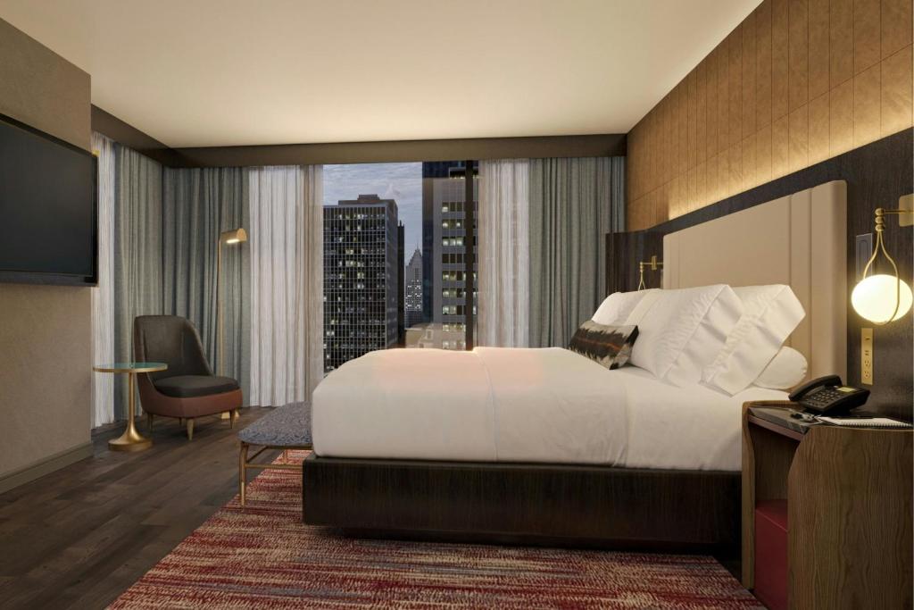 a hotel room with a bed and a view of a city at Hotel Trinity, Autograph Collection in Austin