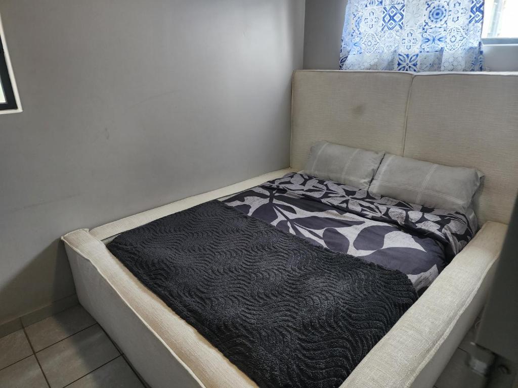 a small bed in a corner of a room at Private Room in a 2-Bed Apartment Shared in Farmall
