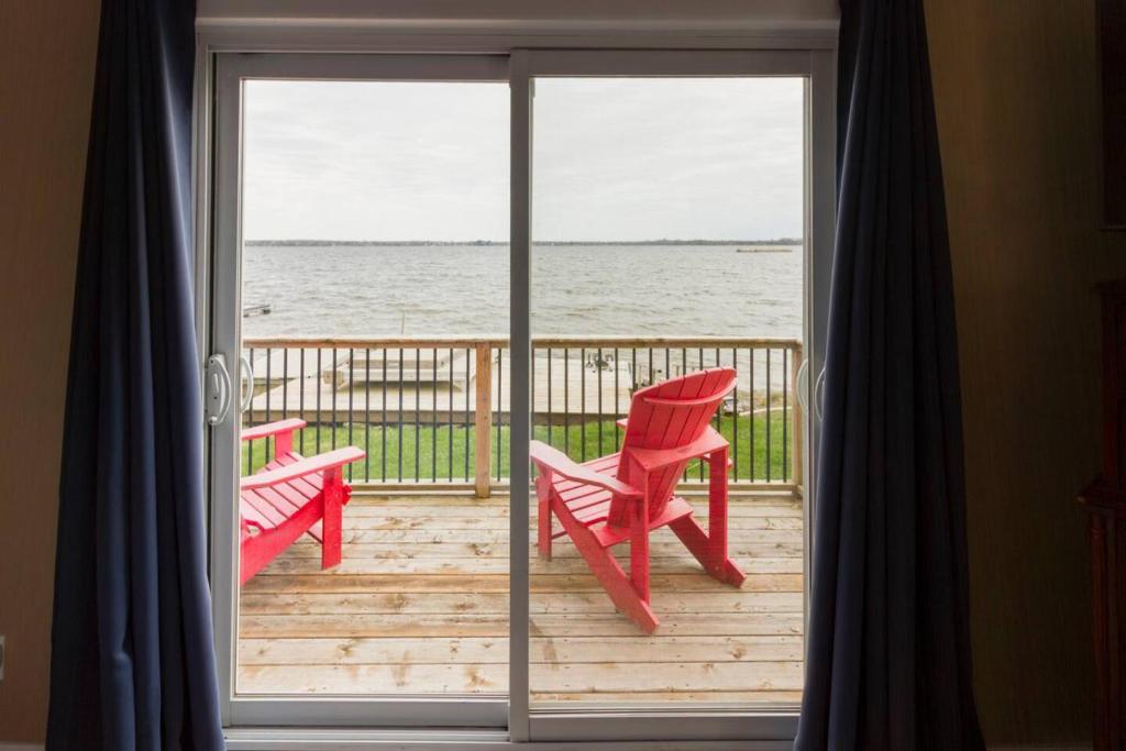 a sliding glass door with a view of the ocean at Whispering Swan Bay Haven in Trenton