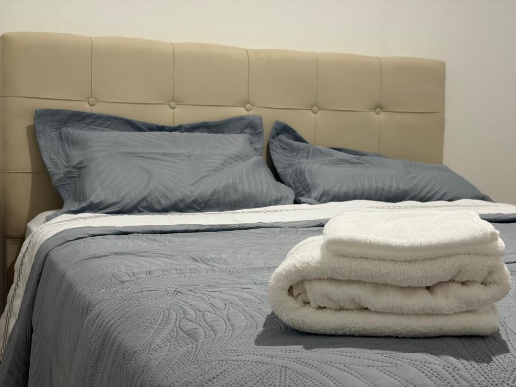 a bed with two white towels on top of it at Alojamiento Yésica in Resistencia